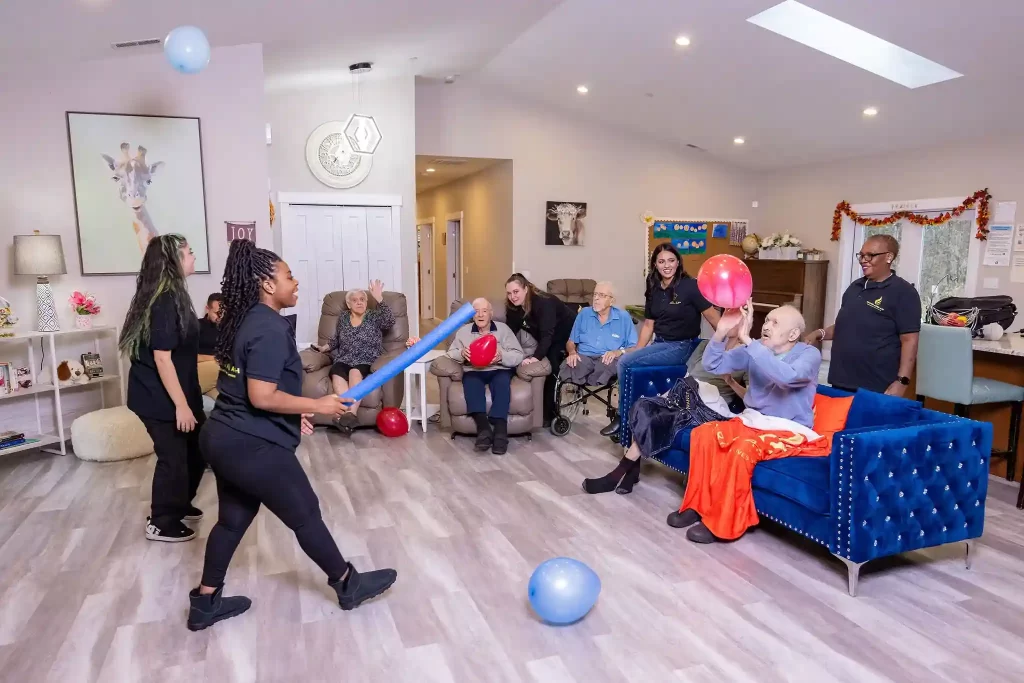 Senior residents engaged in a memory game with staff at a licensed adult family home in Kirkland