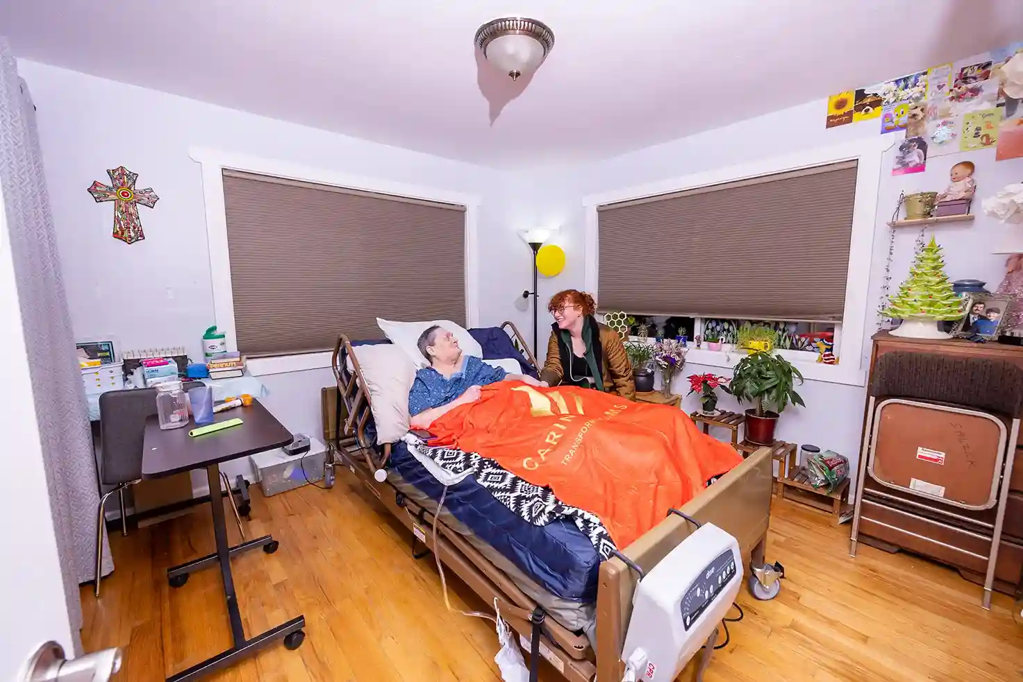 resident getting routine check and personal care from caregivers at caring arms assisted living home