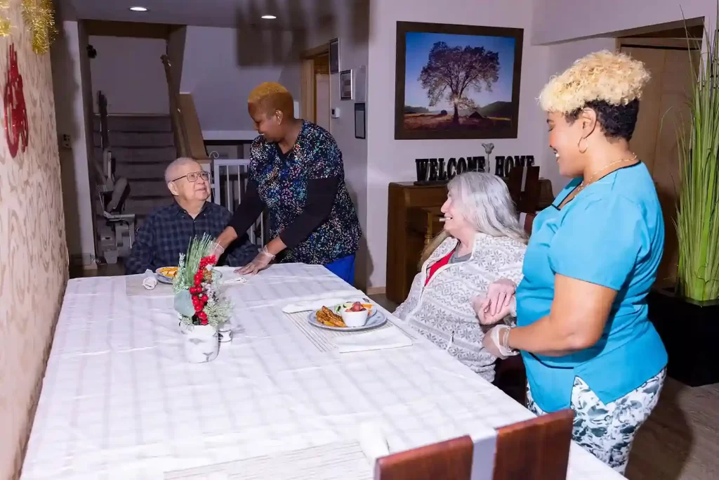 caregivers in Shoreline Assisted Living facility serving fresh food to senior residents