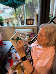 graceful senior resident living life through art and creative learning at Bonney Lake senior living facility